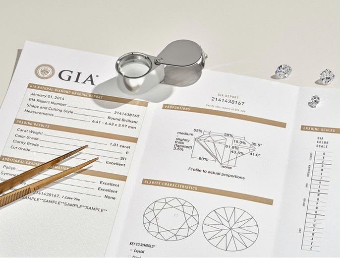 GIA natural diamond grading report with a jeweller’s loupe, tweezers and loose diamonds
