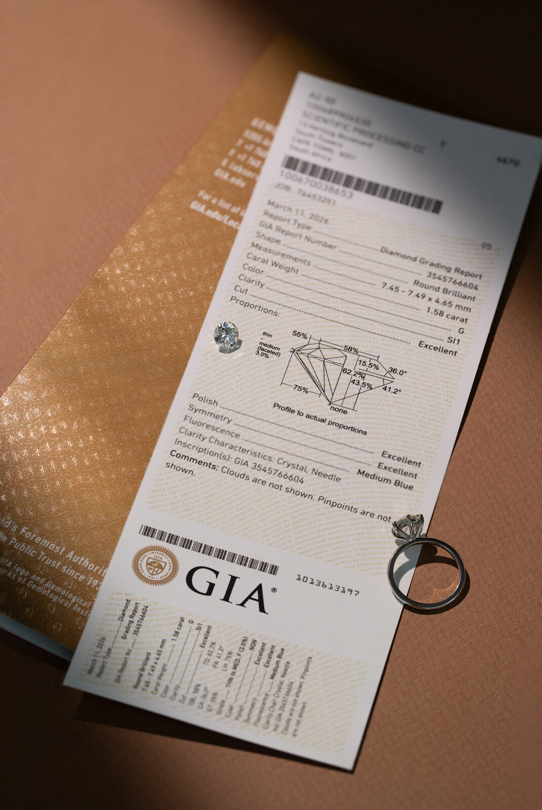 GIA certified natural diamond grading report with an engagement ring, showing certification for a natural diamond